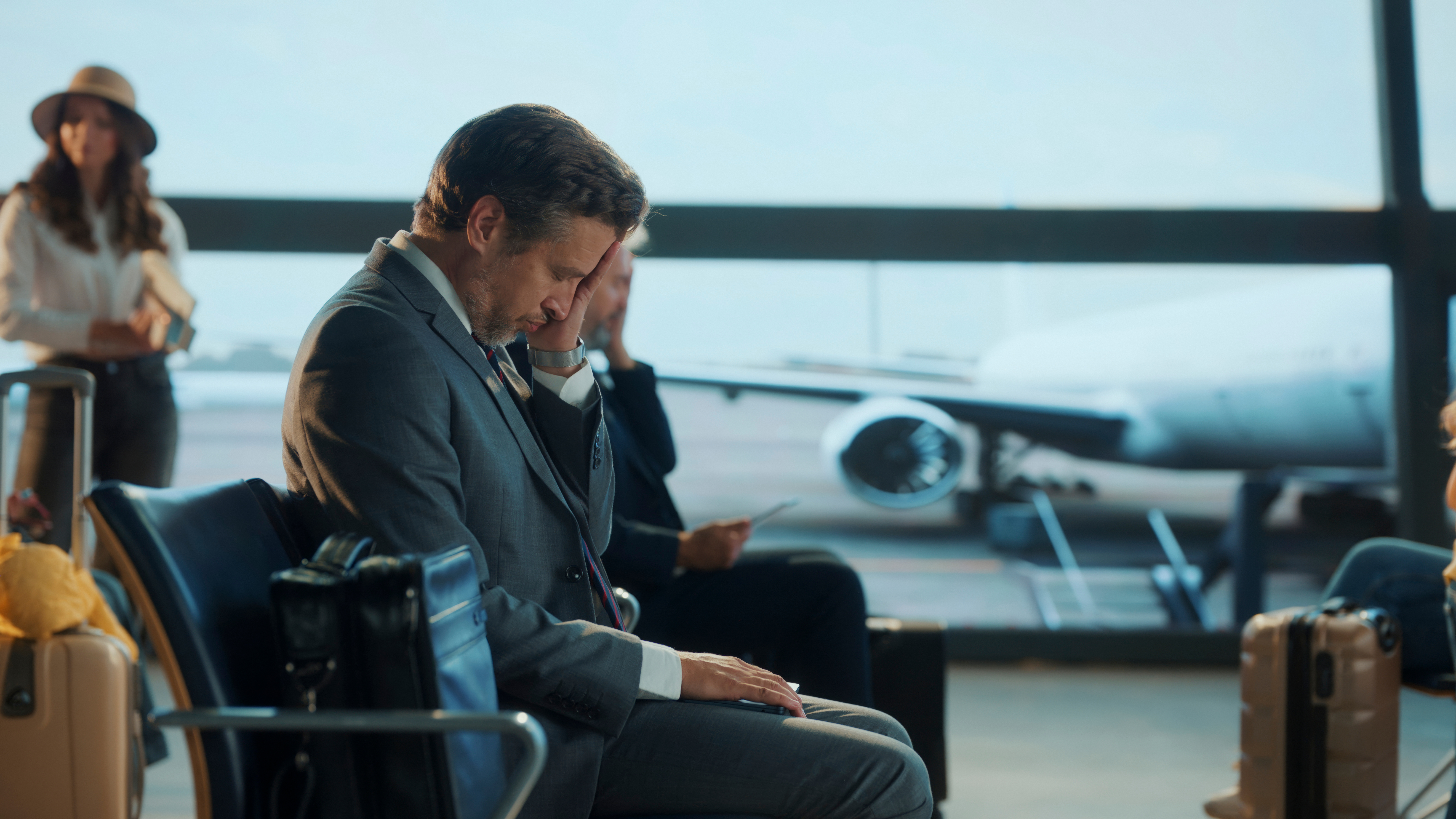 Business traverl showing stress, and fatigue after red eye flight.