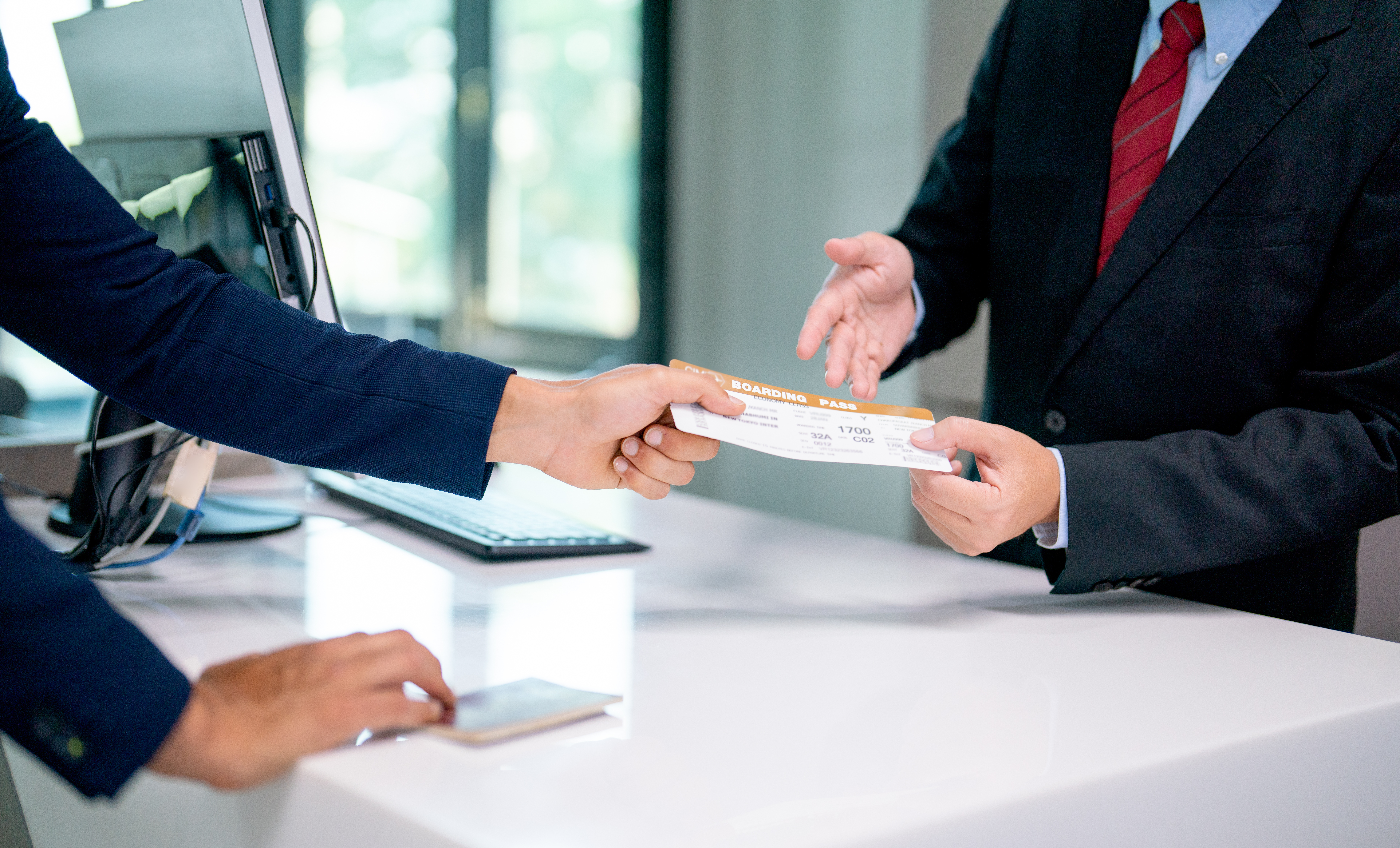 Airline Counter, Customer handing over boarding pass