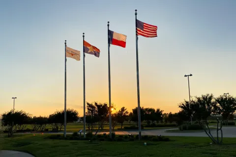American and Texas flags in DFW Founders' Plaza