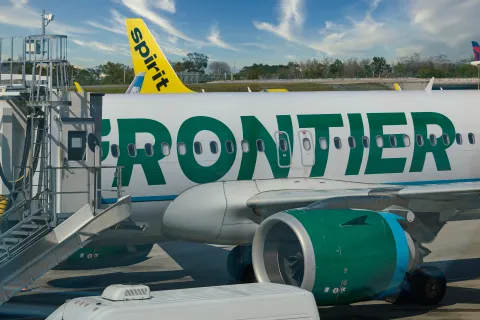 Frontier Jet with a Spritit Tail in the background.