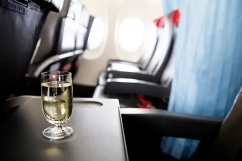 Drink on tray table in plane
