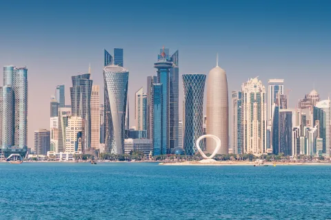30 November 2025, Doha, Qatar: West Bay skyline with various modern skyscrapers rising from the Persian Gulf coastline under a clear blue sky