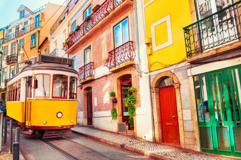 Yellow vintage tram on the street in Lisbon, Portugal. Famous travel destination