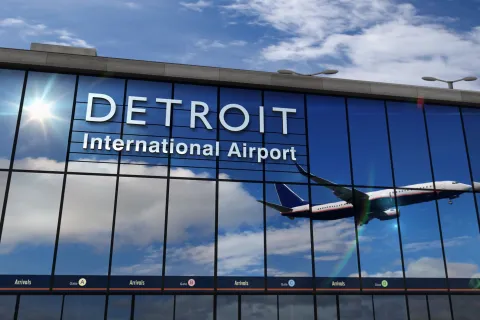 Airplane landing at Detroit Michigan mirrored in terminal