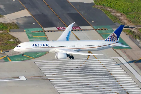 United Airlines Boeing 787-9 Dreamliner aircraft on final approach. Airplane of United Airlines 787 over runway threshold. Plane N24973.