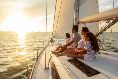 Family travel adventures on luxury yacht at sunset