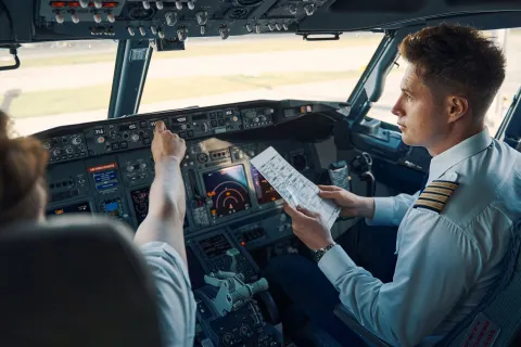Airline captain and first officer sitting in the cockpit