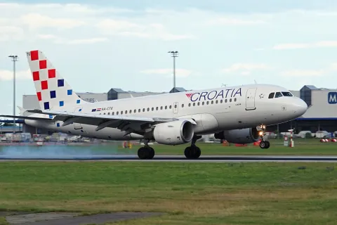 Croatia airline plane landing at Prague airport in beautiful evening light.