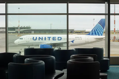 Richmond, BC, Canada - June 13, 2023: An Airbus A319-131 aircraft operated by United Airlines is seen taxiing on the tarmac through terminal lounge windows at Vancouver International Airport (YVR)