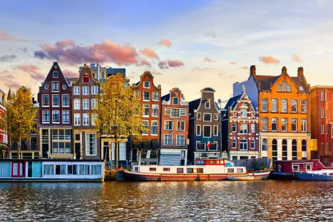 Amsterdam Netherlands dancing houses over river Amstel landmark in old european city spring landscape.