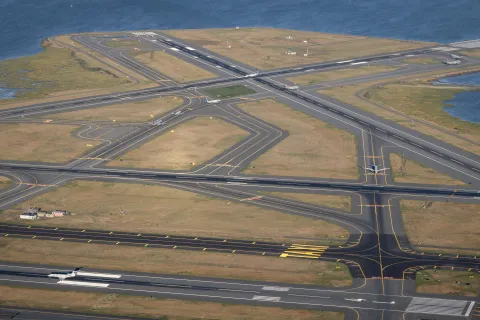 Aerial shot of Boston's Logan International Airport runways with planes taxiing.