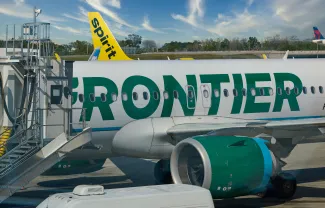 Frontier Jet with a Spritit Tail in the background.