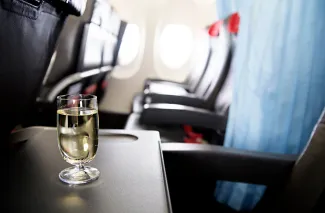 Drink on tray table in plane