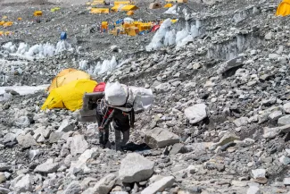 Porters carrying heavy loads to Everest base camp during an expedition in Nepal.