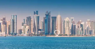 30 November 2025, Doha, Qatar: West Bay skyline with various modern skyscrapers rising from the Persian Gulf coastline under a clear blue sky