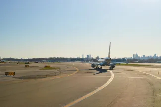 airplane at LaGuardia Airport. LaGuardia Airport is an international airport located in the northern part of Queens, New York City.