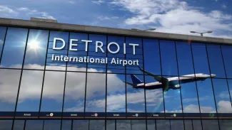Airplane landing at Detroit Michigan mirrored in terminal