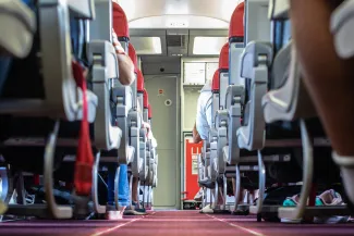 Passengers traveling by a plane, shot from the inside of an airplane