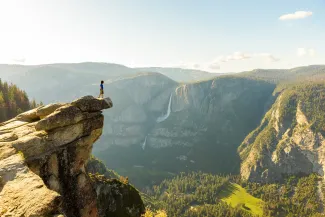 Hiker at the Glacier Point with View to Yosemite Falls and Valley in the Yosemite National Park, California, USA
