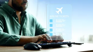 Travel booking for airline tickets using a computer at a desk during the day