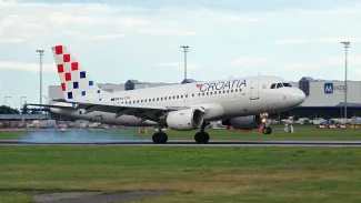 Croatia airline plane landing at Prague airport in beautiful evening light.