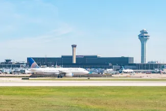 O'Hare Airport, Chicago, Illinois, USA - September 2, 2023 - A United Airlines Airbus taxis in front of the Air Traffic Control tower and Airport Hilton hotel at ORD in Chicago
