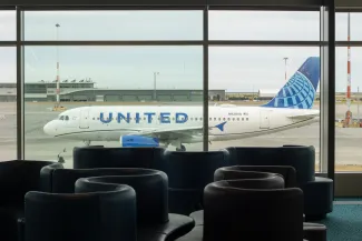 Richmond, BC, Canada - June 13, 2023: An Airbus A319-131 aircraft operated by United Airlines is seen taxiing on the tarmac through terminal lounge windows at Vancouver International Airport (YVR)