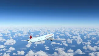 Commercial Boeing 777-200 Air Canada flying over the blue sky