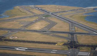 Aerial shot of Boston's Logan International Airport runways with planes taxiing.