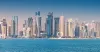 30 November 2025, Doha, Qatar: West Bay skyline with various modern skyscrapers rising from the Persian Gulf coastline under a clear blue sky