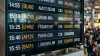 Airport departure board displaying delayed flight status