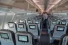 Icelandair flight from Reykjavik to Copenhagen. Boeing 757 cabin interior after people got off the plane upon arrival. Glow of the infotainment screens.