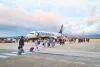 Travelers Boarding Ryanair Plane at Airport Runway during Sunset