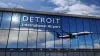 Airplane landing at Detroit Michigan mirrored in terminal