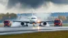 Type to edit Change background Remove background Expand image Animate image Change mood Change color Airplane emergency landing runway fire trucks smoke aviation safety AI generated