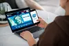 Woman holding smartphone with ESTA Electronic System for Travel Authorization logo, filling form to travel to the United States under the Visa Waiver Program 