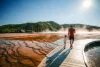 Father and daughter walking boardwalk at Midway Geyser Basin in Yellowstone National Park