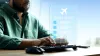 Travel booking for airline tickets using a computer at a desk during the day