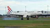 Croatia airline plane landing at Prague airport in beautiful evening light.
