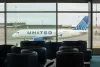 Richmond, BC, Canada - June 13, 2023: An Airbus A319-131 aircraft operated by United Airlines is seen taxiing on the tarmac through terminal lounge windows at Vancouver International Airport (YVR)